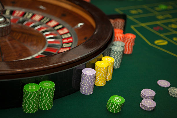 Green cloth on the roulette table. Placing chips in casino